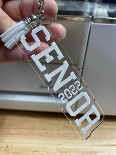 Give your graduate the keys to success!! Large 2022 personalized graduation key chain.  Two options available Name or Senior. Wood engraved or acrylic engraved color options are clear, mirrored rose gold or mirrored silver Measures 4 1/2X1 1/4.  These can be used as zipper pulls on gym bags, book bags, purses, coats or to just hang on car mirror. To get back to my shop click below 👇🏻  https://homeandsparrowshop.etsy.com LETS GET SOCIAL! Follow me on Instagram @homeandsparrow Graduation Keychain, Keys To Success, Book Bags, Gym Bags, Zipper Pulls, Car Mirror, Silver Mirrors, Bags Purses, Key Chain