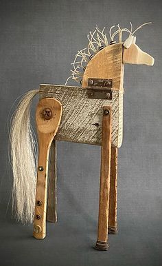 a wooden toy horse with long white hair