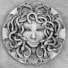 the face of a woman with long hair and octopus tentacles on it's head