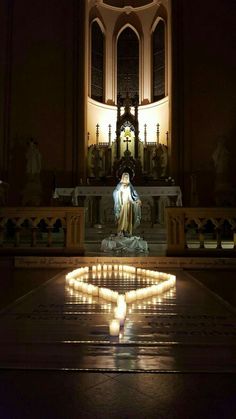 a lit up statue in the middle of a church