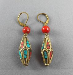 Materials:   25mmX10mm Tibetan/Nepal Brass beads, green turquoise,red coral inlaid, 6mm Coral beadsLength: 1"Weight: 8gClosure:    Brass/copper lever back hooks, nickel free Red Beaded Brass Jewelry, Red Brass Jewelry With Round Beads, Artisan Red Brass Jewelry, Nickel-free Red Brass Earrings, Tibetan Turquoise, Pearl Earrings Dangle, Coral Beads, Dangling Earrings, Coral Turquoise