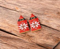 red and white beaded earrings on wooden surface