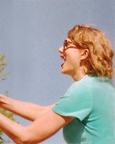 a woman holding a tennis racquet on top of a tennis racket in her hands