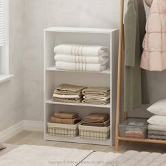 a white shelving unit with folded towels and folded blankets on it's sides