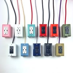 several different colored electrical outlets on a white wall