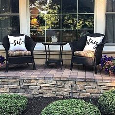 two chairs and a table on a patio