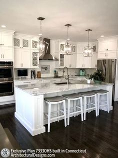 a large kitchen with white cabinets and marble counter tops, an island in the middle is surrounded by stools