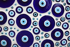 blue and white circles with black dots on the bottom are arranged in an abstract manner