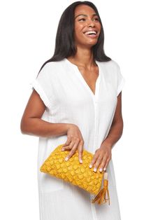 Crocheted raffia clutch with cotton lining. Zip closure and leather tassel. 11” x 7” x 2”. Solid yellow. Chic Woven Clutch For Travel, Chic Vacation Clutch With Braided Handles, Chic Straw Bag With Tassels, Chic Woven Travel Clutch, Woven Leather Pouch Straw Bag, Vacation Clutch With Braided Handles, Chic Crochet Bag With Tassels For Travel, Chic Straw Bag With Fringe, Chic Crochet Travel Bag With Tassels