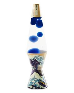 a tall glass vase with blue and white designs on the bottom, sitting in front of a white background