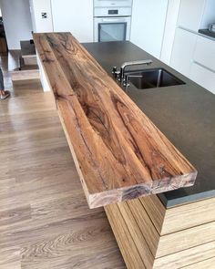 a wooden counter top sitting in the middle of a kitchen