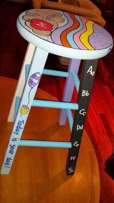 a colorful stool with writing on it