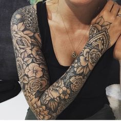 a woman with tattoos on her arms and arm