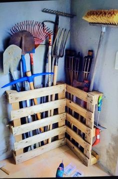 a bunch of wooden pallets stacked on top of each other next to a refrigerator