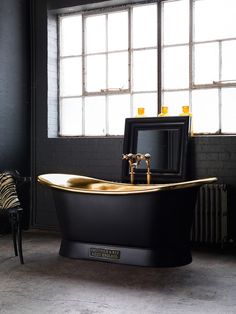 an old fashioned bathtub in front of a window with zebra prints on the floor