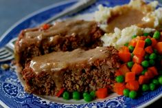 a blue plate topped with meatloaf and mashed potatoes