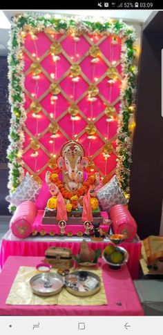 an idol sitting on top of a pink table