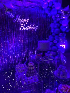 a birthday party with purple lights and balloons