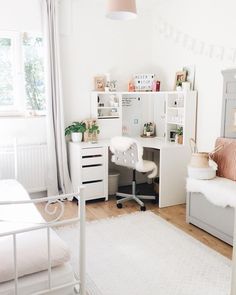 a bedroom with a bed, desk and chair in the corner next to a window