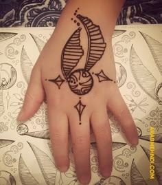 a person's hand with a tattoo on it and an arrow in the middle