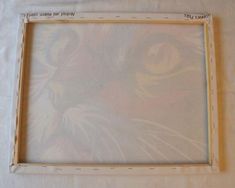 an image of a cat's face on a white sheeted background with the frame cut out