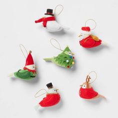 christmas ornaments are arranged in the shape of birds and santa's helper hats