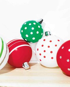 christmas ornaments are lined up on a shelf in front of a white wall with polka dots