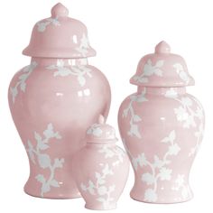 three pink vases with white flowers and leaves painted on the sides, one has a lid