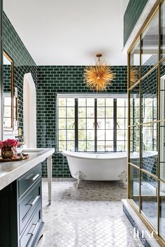 a bath room with a tub a sink and a window