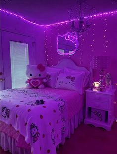 a hello kitty themed bedroom with pink lighting and bed linens in the room,