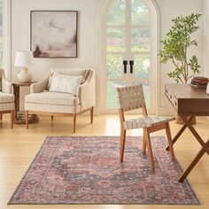 a living room filled with furniture and a large rug on top of a hard wood floor