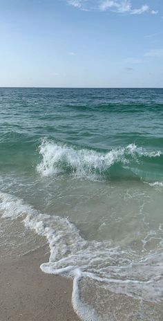 the ocean waves are rolling in to shore