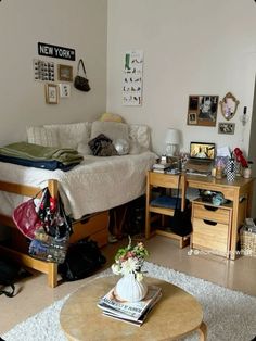 a living room filled with furniture and clutter on the floor in front of a bed