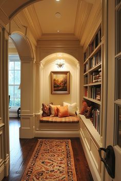 a room with a couch, bookshelf and rug on the floor