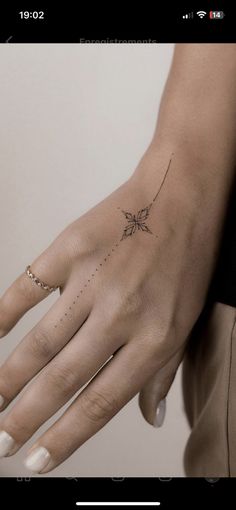 a woman's hand with a star tattoo on it