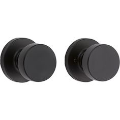 two black knobs on the side of a white wall