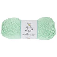 a ball of yarn with the words baby beed in white and green on it