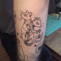 a tattoo on the leg of a man that has a rat and an octopus in it