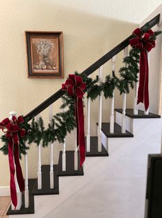 christmas garland on the banisters with red bows