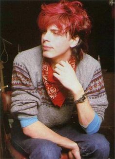 a young man with red hair wearing a scarf