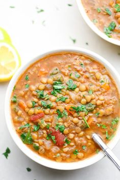 two bowls filled with lentula soup and garnished with parsley