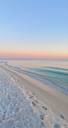 the beach is covered in white sand and footprints