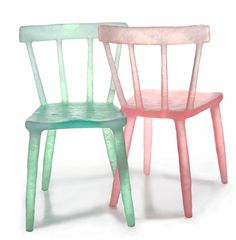 two plastic chairs sitting next to each other