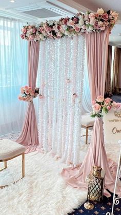 a pink and white wedding ceremony setup with flowers