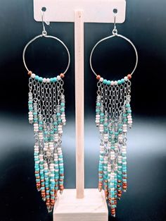 Southwest Style Shoulder Duster Earrings in Turquoise, Cream and Orange on Silver Hoops - Etsy Bohemian Turquoise Beaded Chain Earrings, Turquoise Bohemian Earrings With Beaded Chain, Turquoise Dangle Hoop Earrings With Colorful Beads, Bohemian Beaded Chain Dangle Chandelier Earrings, Bohemian Beaded Chandelier Dangle Earrings, Bohemian Chandelier Earrings With Beaded Chain, Turquoise Earrings With Beaded Chain, Turquoise Earrings With Beaded Chain And Round Beads, Bohemian Orange Jewelry With Dangling Beads