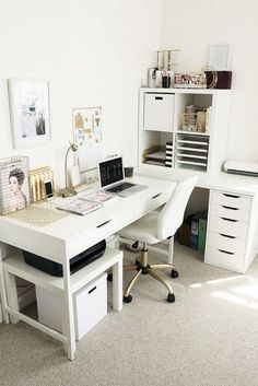 a white desk with drawers and a laptop on it in a room that has carpeted flooring