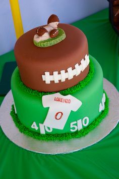 two tiered cake decorated with footballs and shirts