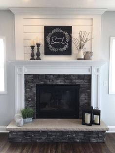 a fireplace with a mantle and candles on it