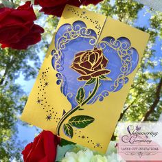 a close up of a greeting card with roses in the foreground and trees in the background