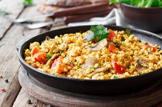 a pan filled with food sitting on top of a wooden table